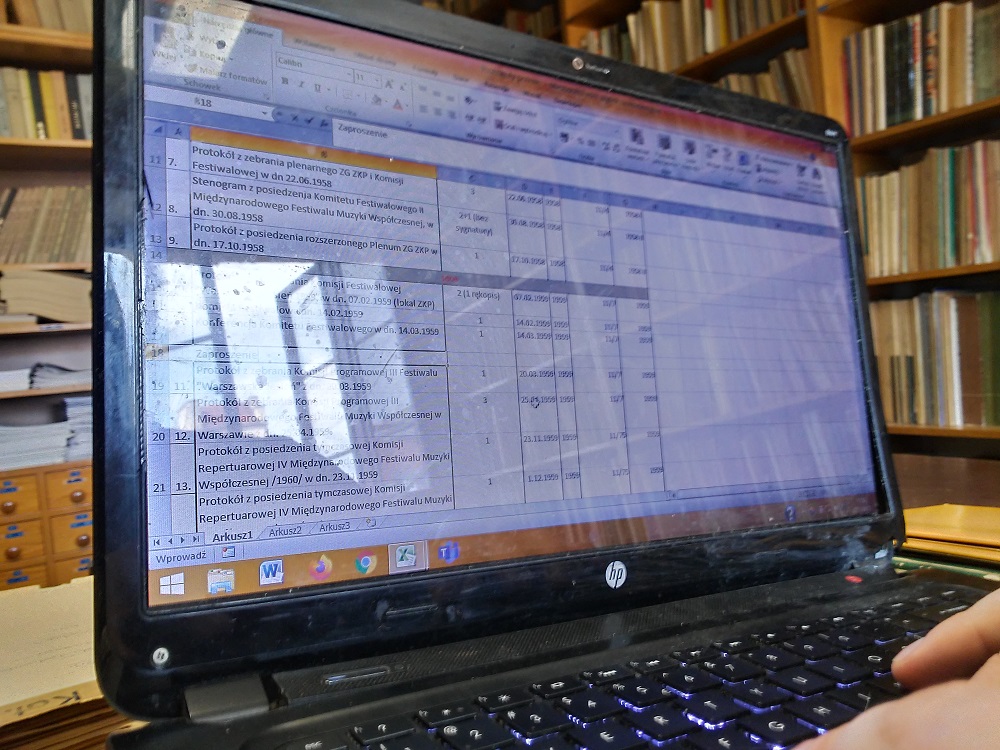 A photo - a laptop monitor and library collections