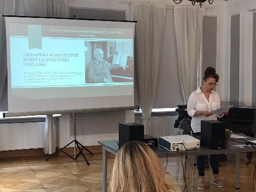 A photo - Olena Beregova speaking during symposium