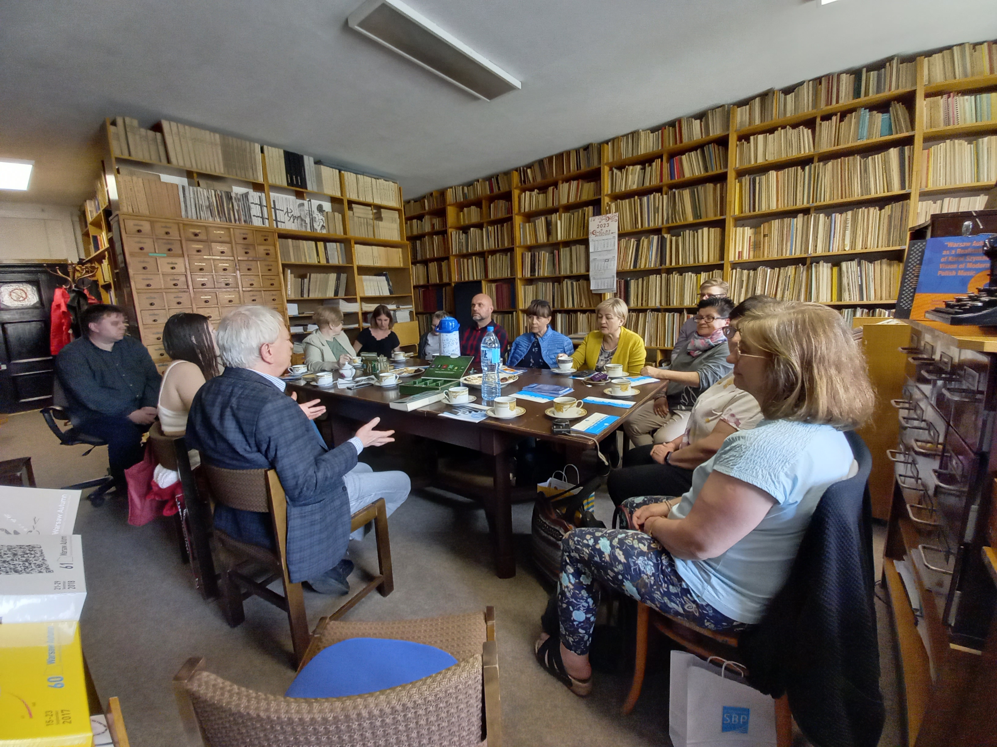 A photo - librarians sitting by the table  